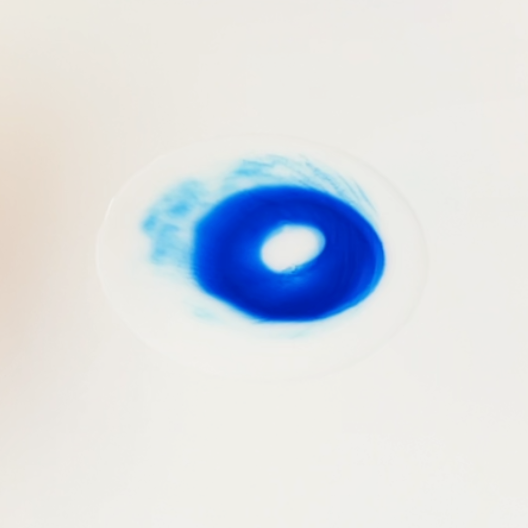 Concentric blue ink ring expansion illustrating controlled liquid movement across a non-absorbent surface by VHacademy