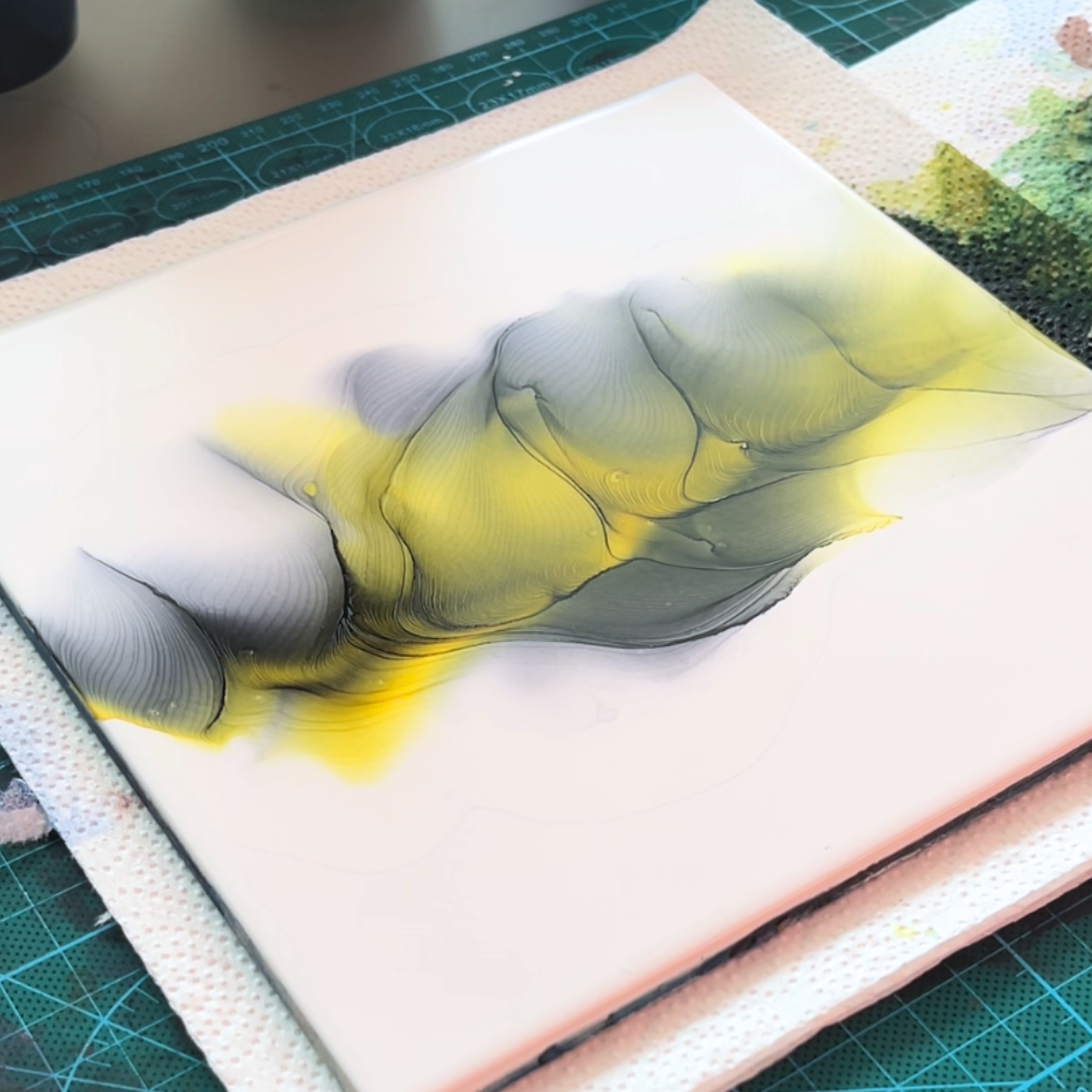 Layered fluid waves of charcoal grey and chartreuse lime yellow alcohol ink illustrating ink velocity by VHacademy