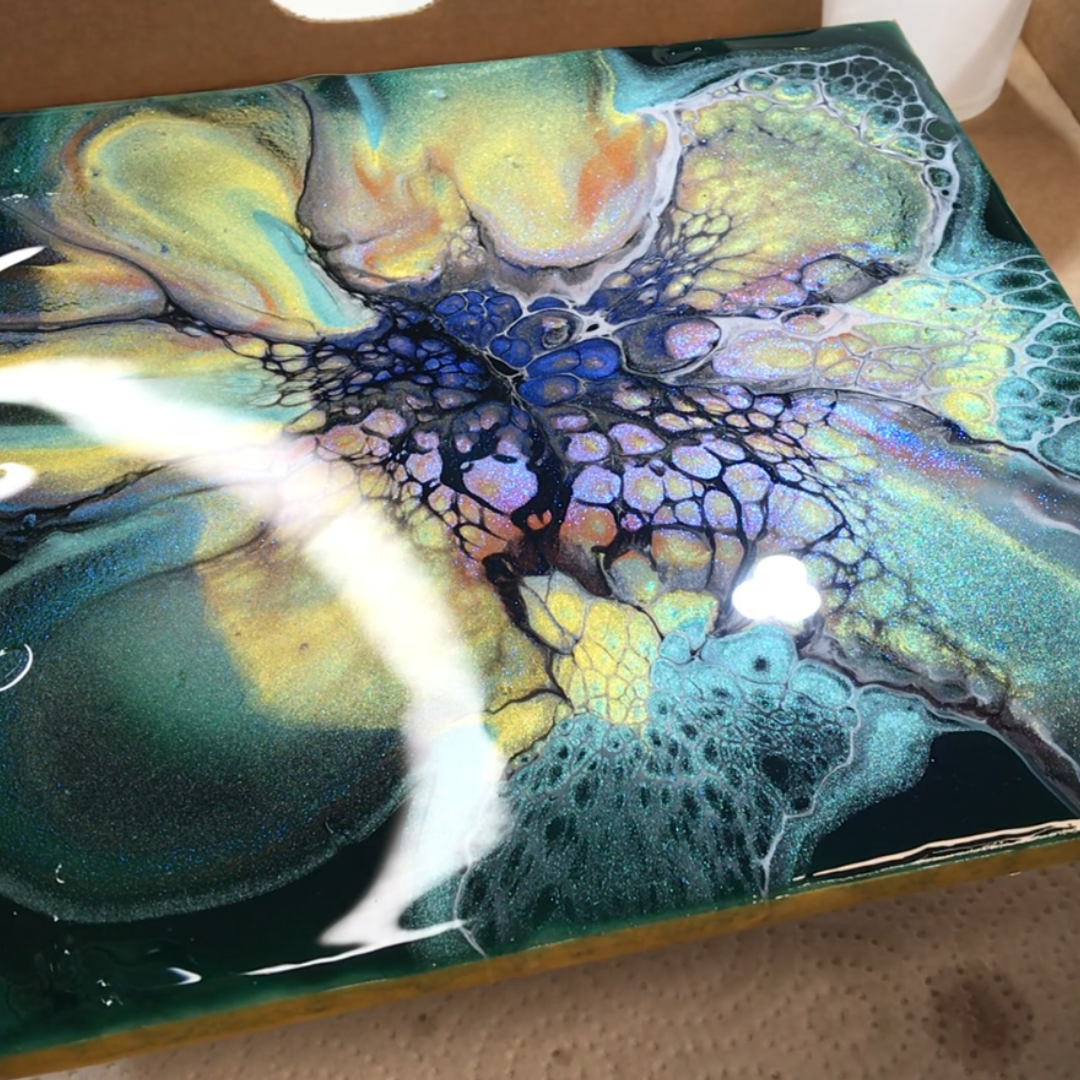 Expansive glossy acrylic pour art demonstrating central webbed bloom structures in yellow, teal, and blue by VHacademy