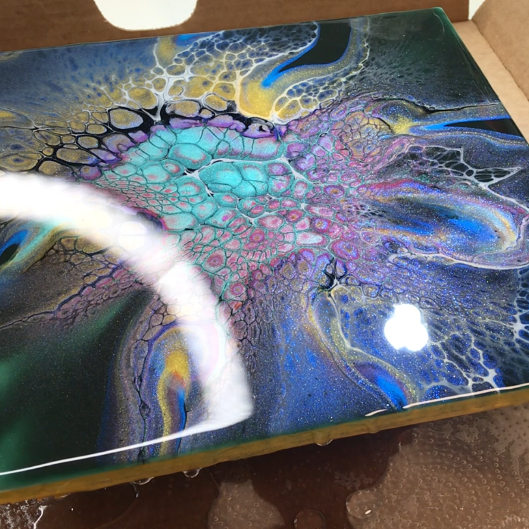 Glossy high-shine resin bloom artwork featuring intricate turquoise, violet, and gold lacing cell structures by VHacademy