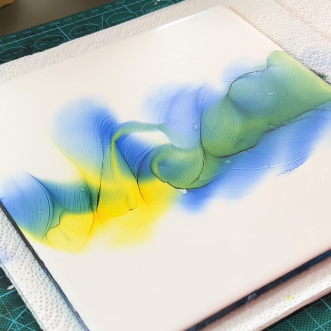 Fluid movement of vivid canary yellow and electric cyan blue alcohol ink on white canvas by VHacademy