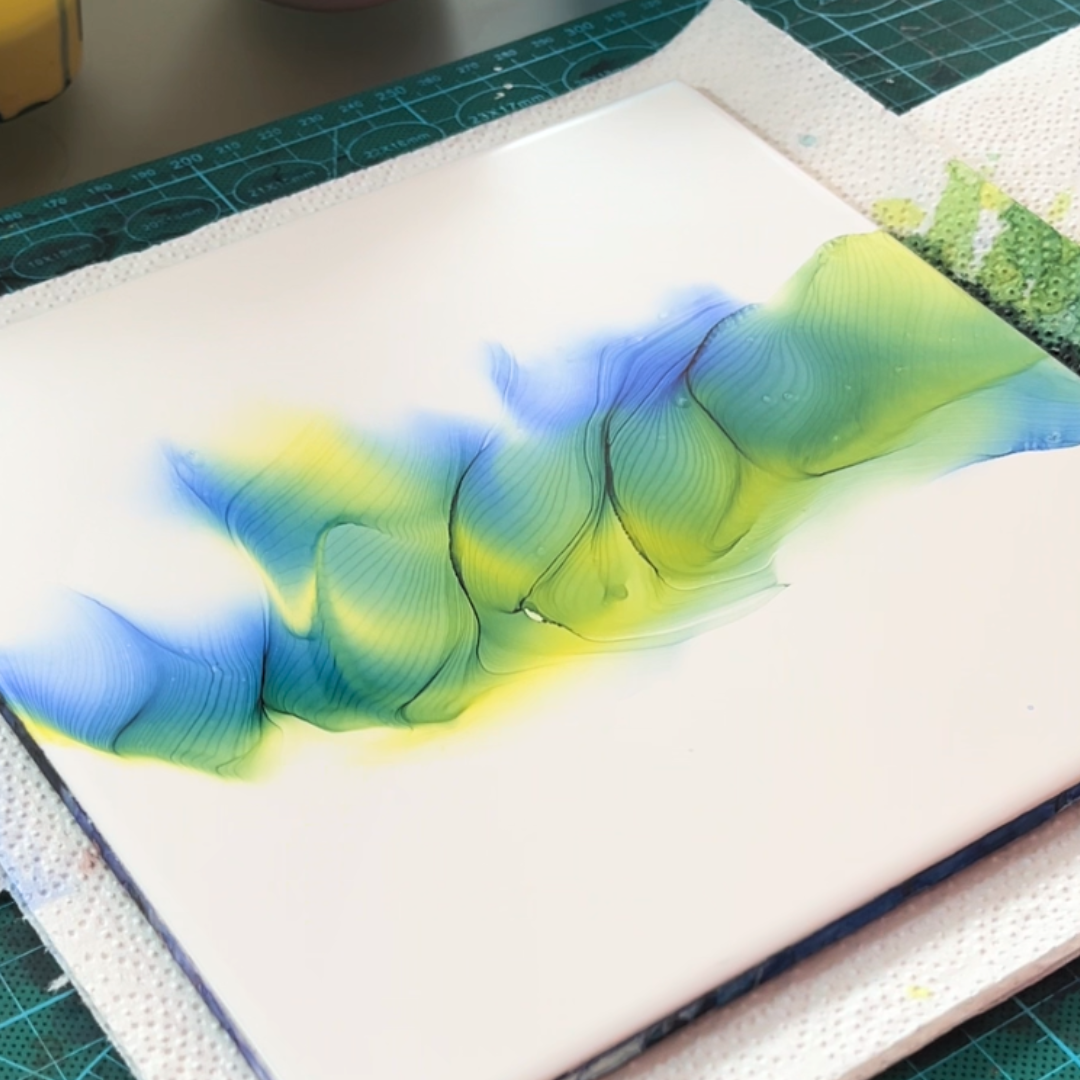 Fluid movement of vivid canary yellow and electric cyan blue alcohol ink on white canvas by VHacademy