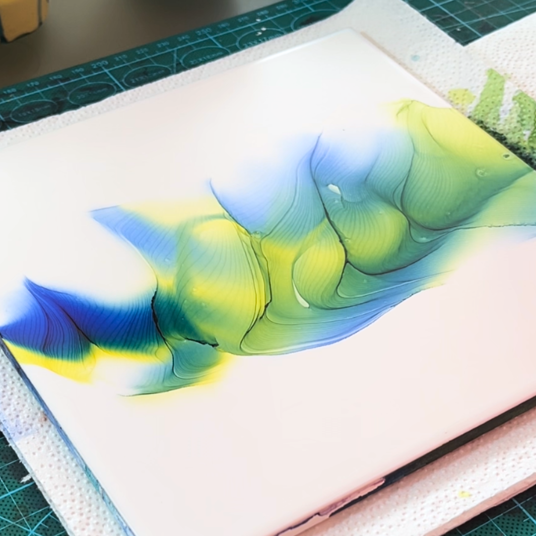 Fluid movement of vivid canary yellow and electric cyan blue alcohol ink on white canvas by VHacademy