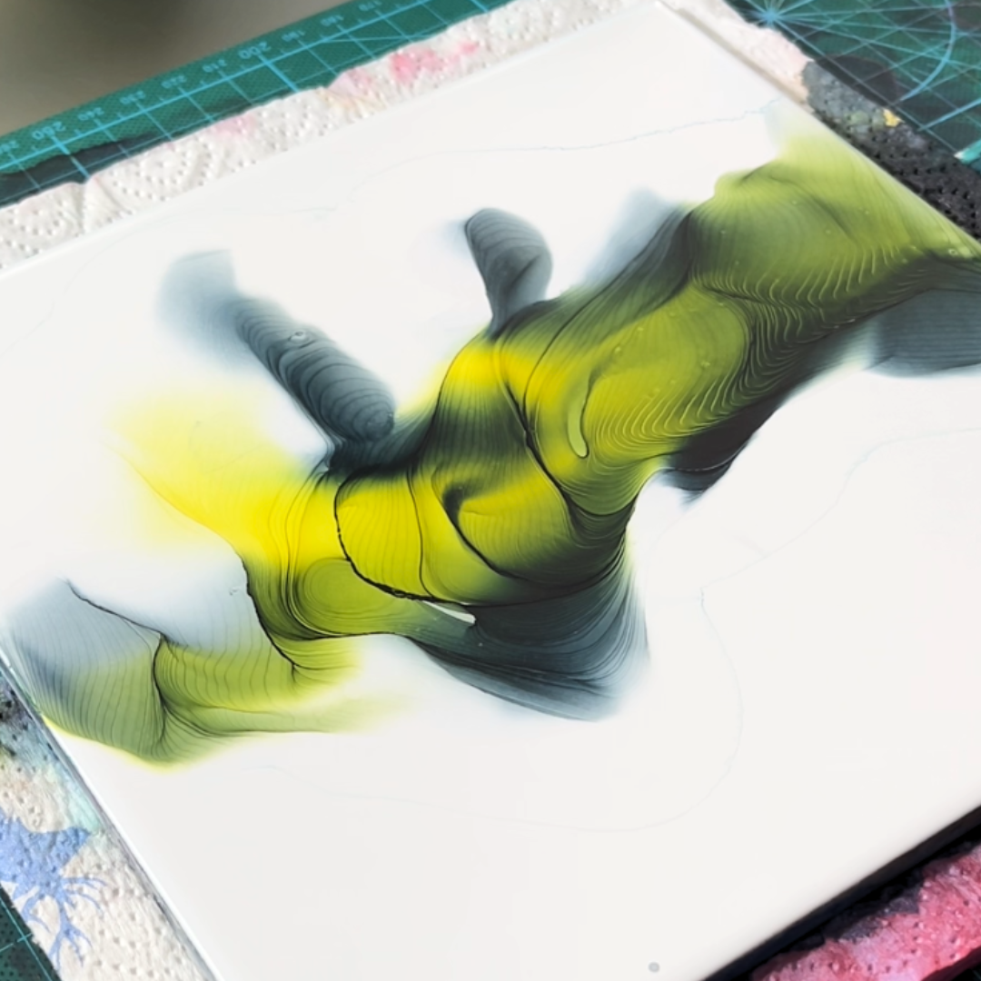 Centrally dispersed yellow and muted dark green alcohol ink showcasing fluid pooling and edge definition by VHacademy